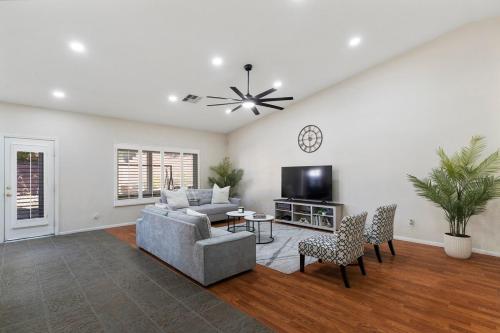 a living room with a couch and a tv at Bold Blue Retreat in Henderson in Las Vegas