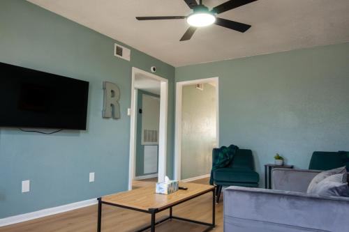 a living room with a couch and a ceiling fan at Near KYLE! - Gorgeous Georgia Getaway in College Station