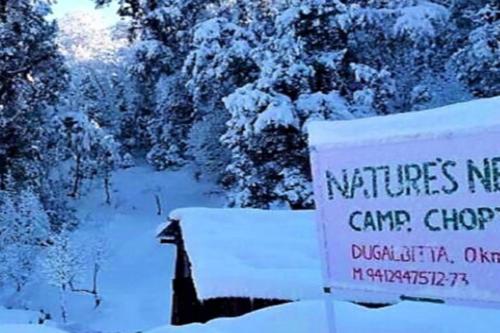 a sign that says turtlesmite camp car dealership in the snow at Camping at Natures Nest in Sari
