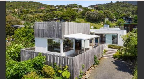 an aerial view of a house with a fence at Surf fortress in Raglan