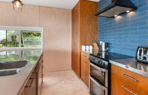 a kitchen with a sink and a stove at Surf fortress in Raglan