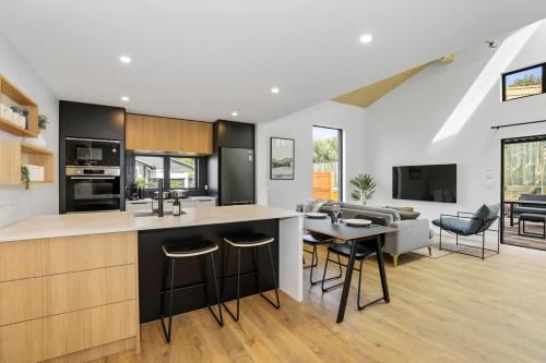 a kitchen and living room with a table and chairs at The Sanctuary in Rotorua