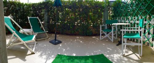 a group of chairs and a table on a patio at Lungomare Hotel in Marina di Cecina