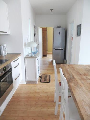 a kitchen with a wooden table and a refrigerator at Dorothee V6W5 in Dierhagen