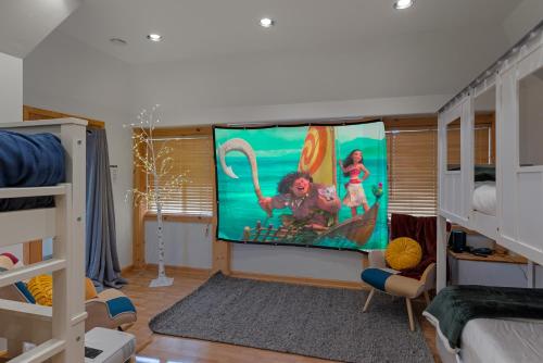 a room with a large screen in the middle of a bedroom at Remodeled 4BDR Cabin with AC Lake Views Hot-Tub Bunk Room Excellent Location in Kings Beach