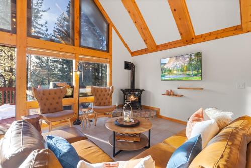 a living room with a couch and a fireplace at Remodeled 4BDR Cabin with AC Lake Views Hot-Tub Bunk Room Excellent Location in Kings Beach