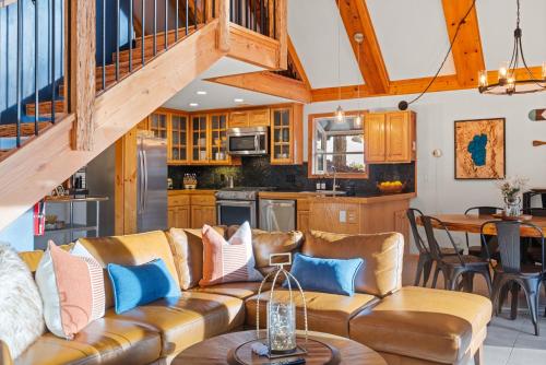 a living room with a couch and a table at Remodeled 4BDR Cabin with AC Lake Views Hot-Tub Bunk Room Excellent Location in Kings Beach