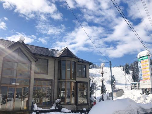 a house in the snow in front of a ski slope at Birdland - Vacation STAY 81132v in Seki