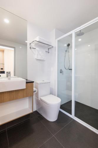 a bathroom with a toilet and a sink and a shower at Ibis Styles Hobart in Hobart