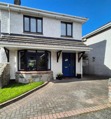 a house with a blue door and a brick driveway at Renovated 3 Bedroom Heritage Home with Garden in Ardee in Ardee