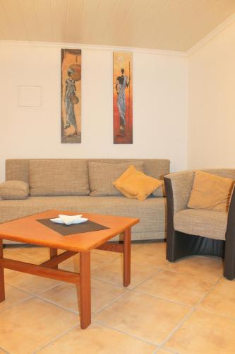 a living room with a couch and a coffee table at Kleiner Bungalow in Grömitz