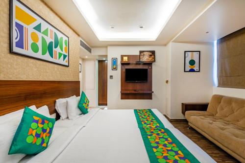 a hotel room with a bed and a couch at Treebo Premium Twin Star in Chennai