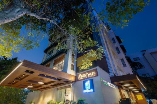 a building with a sign in front of it at Treebo Premium Twin Star in Chennai