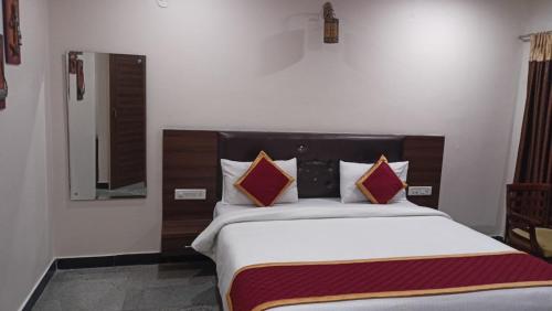a bedroom with a large bed in a room at Picket And Bhaskar Hotels Pvt Ltd in Srīkākulam