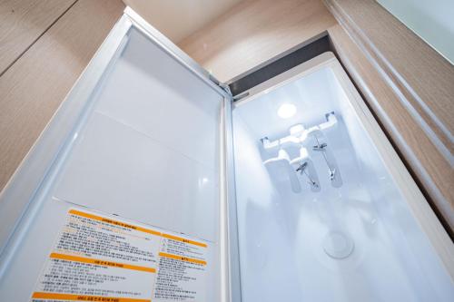 a shower stall with a sink in a bathroom at Hound Hotel DaeGu in Daegu