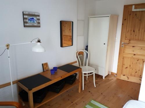 a room with a table and a chair and a door at Alte Mühle Schleiblick in Maasholm-Bad