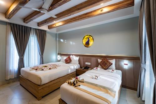 Postel nebo postele na pokoji v ubytování Hotel Seven Limited