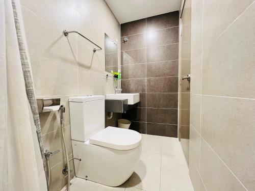 a bathroom with a toilet and a sink and a shower at Pinnacle Pj by DeUrban in Petaling Jaya