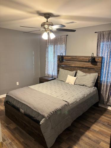 a bedroom with a large bed with a ceiling fan at CeloVacationHousing in Memphis
