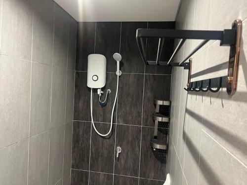 a shower in a bathroom with a shower head at Edumetro 3 bedroom Subang Sunway By MICASA GROUP in Subang Jaya