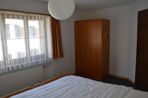 a bedroom with a bed and a window at Bellevue in Pany