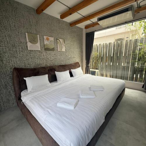 a bedroom with a large bed with two towels on it at Huahin House Premium in Hua Hin