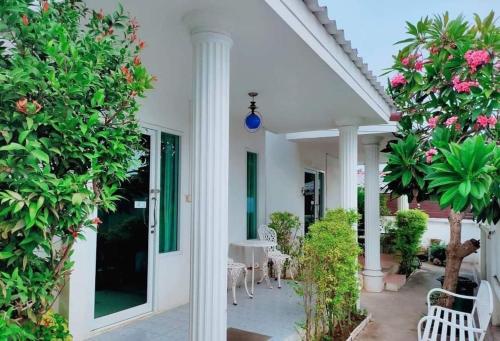 a patio with a table and chairs and trees at Thongtalay Bed & Breakfast Koh Larn in Ko Larn