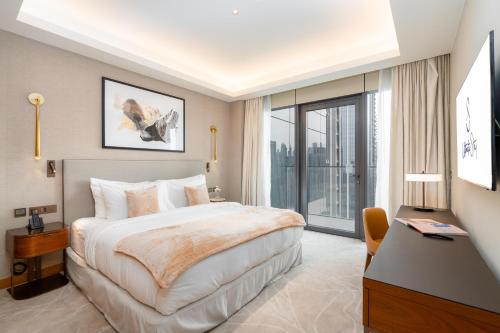 a hotel room with a bed and a large window at Ultimate Stay Luxurious Address Opera 2BR Next to Burj Khalifa and Dubai Mall Large Balcony with Stunning Views in Dubai