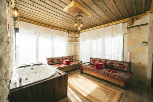 a large room with a jacuzzi tub in a building at İncebey Konak Cappadocia in Uçhisar