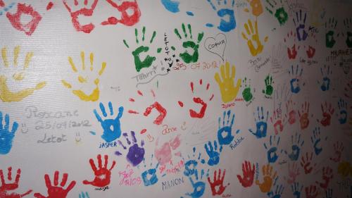 a wall covered in lots of hand prints at Vayamundo Houffalize in Houffalize
