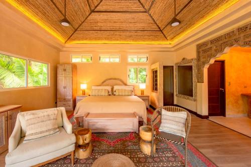 1 dormitorio con cama, sofá y sillas en Jazz Studio, en Nosara