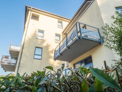 an apartment building with a balcony and plants at Ostseeresidenz - Whg 17 in Groß Kirr