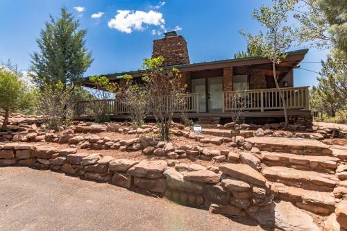 a home with a stone retaining wall and a house at Glass House Elk Rim Pine in Pine