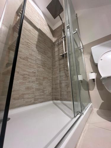 a shower with a glass door in a bathroom at Avaja - Daria's apartment in Taormina