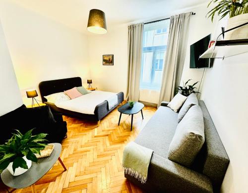 a living room with a couch and a bed at Apartments by Jacob in Prague