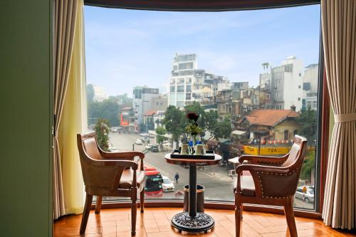 a room with a large window with a view of a city at 12 A&B Điện Biên Phủ Hà Nội Hotel in Hanoi