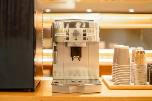 a coffee machine sitting on top of a counter at GOZAN HOTEL & SERVICED APARTMENT Higashiyama Sanjo in Kyoto