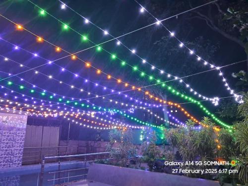 a string of lights over a patio at night at Luxury Villa Large Private Pool in Raichak