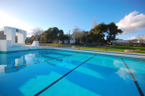 a large swimming pool with blue water at Pedras D'el Rei Villa V1 in Tavira