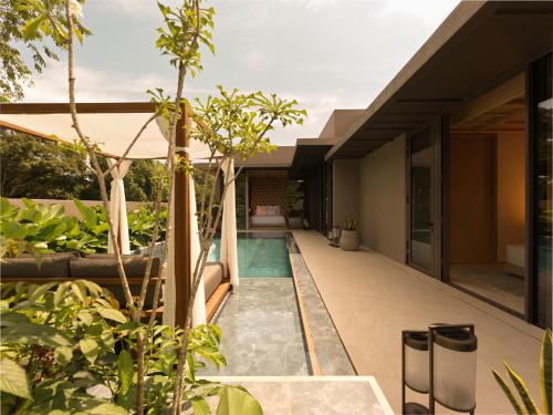 an external view of a house with a swimming pool at Raffles Sentosa Singapore in Singapore