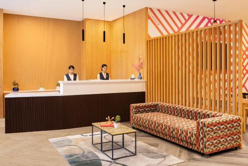 two people at a reception desk in a lobby at Ginger Nagpur City Centre in Nagpur