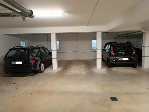 two cars are parked in a parking garage at Franzl Hof Zorell in Ravensburg