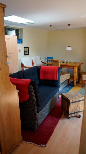 a living room with a blue couch and a table at Rücker in Eckernförde