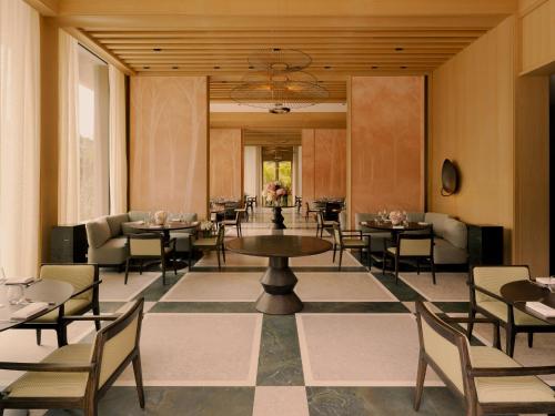 a dining room with tables and chairs in a building at Raffles Sentosa Singapore in Singapore