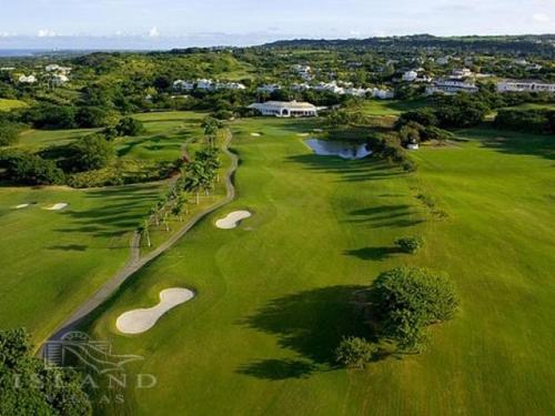 an overhead view of a golf course with two golf greens at Royal Westmoreland Benjoli Breeze, Palm Ridge 10 by Island Villas in Saint James
