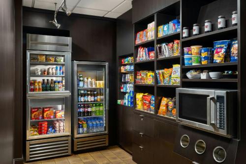 a grocery store with a refrigerator and lots of food at Courtyard by Marriott Myrtle Beach Barefoot Landing in Myrtle Beach