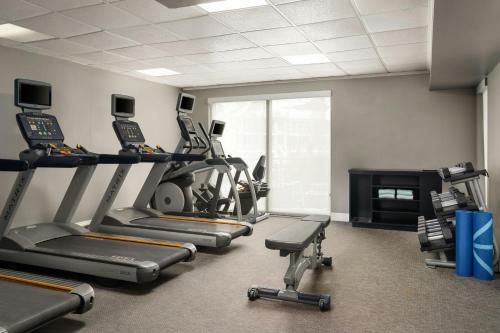 a gym with cardio machines and a fireplace at Courtyard by Marriott Myrtle Beach Barefoot Landing in Myrtle Beach