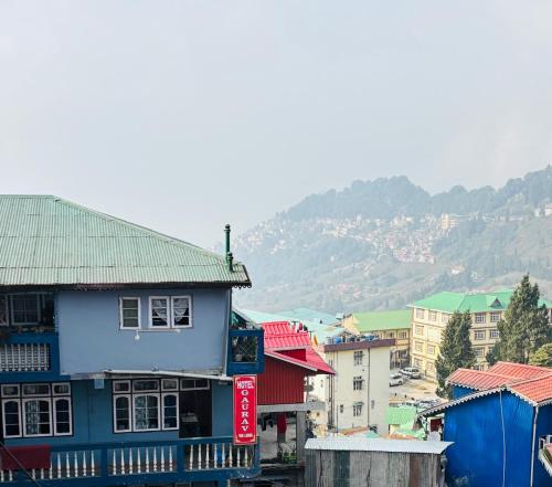 a group of buildings with a mountain in the background at Gaurav Retreat By StayApart in Darjeeling