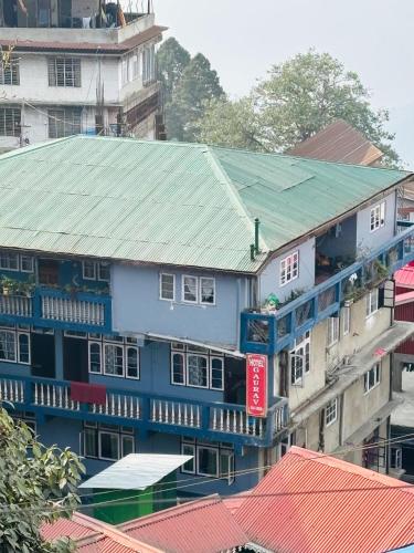 a group of buildings with a green roof at Gaurav Retreat By StayApart in Darjeeling