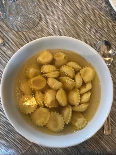 a white bowl of food with bananas in it at Agriturismo Battibue in Fiorenzuola dʼArda
